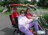Biking together Quadribent recumbent bikes for two with rumble seat and sunroof canopies