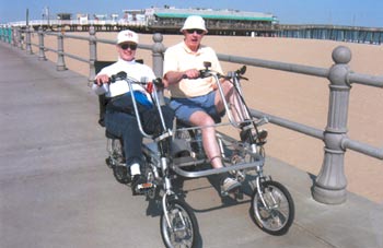 Biking with their Quadribent on the boardwalk in Virginia Beach, Virginia.